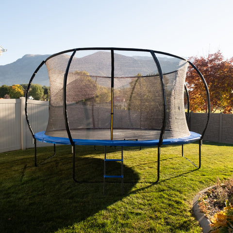 JumpYeti trampoline photographed outdoors with blue padding and enclosure net