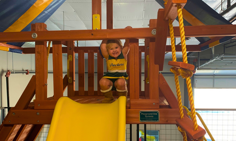 Kid on a swing set at the Schertz store